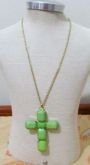 Crucifixo dourado com pedras verdes